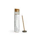 A bamboo incense stick displayed next to its clear glass storage tube with a cork stopper and a white printed label. The tube is labeled 'JAN NING' and 'NATURAL INCENSE STICK'.