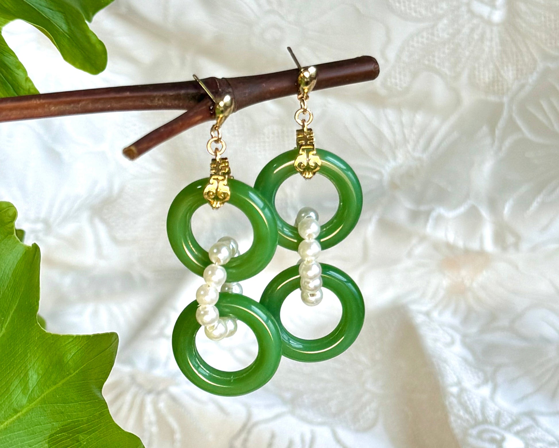 Ancient Chinese style earrings, a drop earrings with dual green rings chained with white pearls, front view of the product.