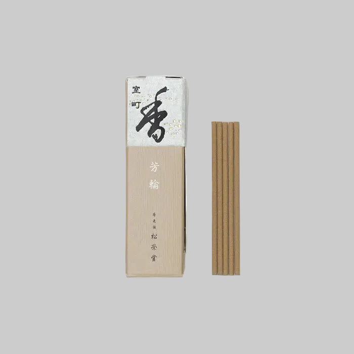 Incense stick box with incense sticks on an off-white background