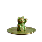 Oxidated copper color cat-shaped incense stand on a transparent background