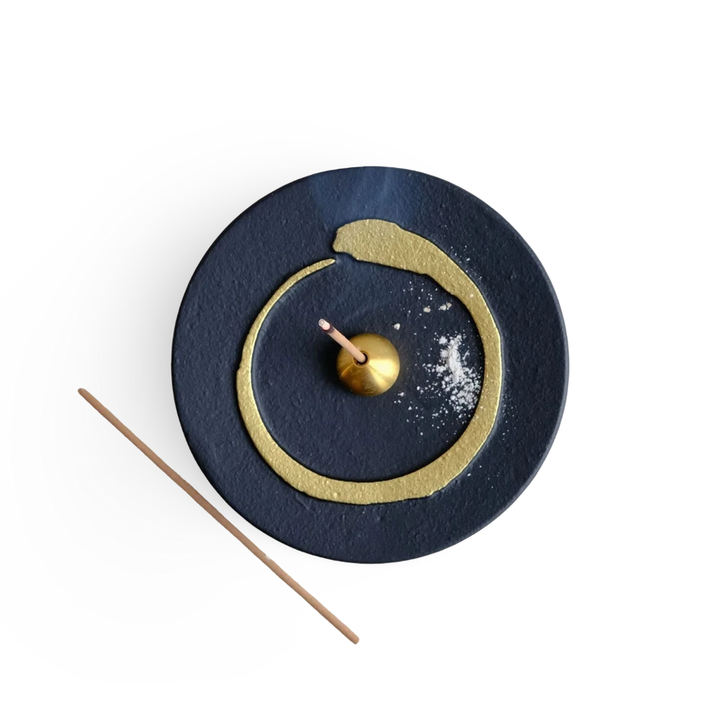 Decorative incense holder with buddhism enso gold circle design on a white background