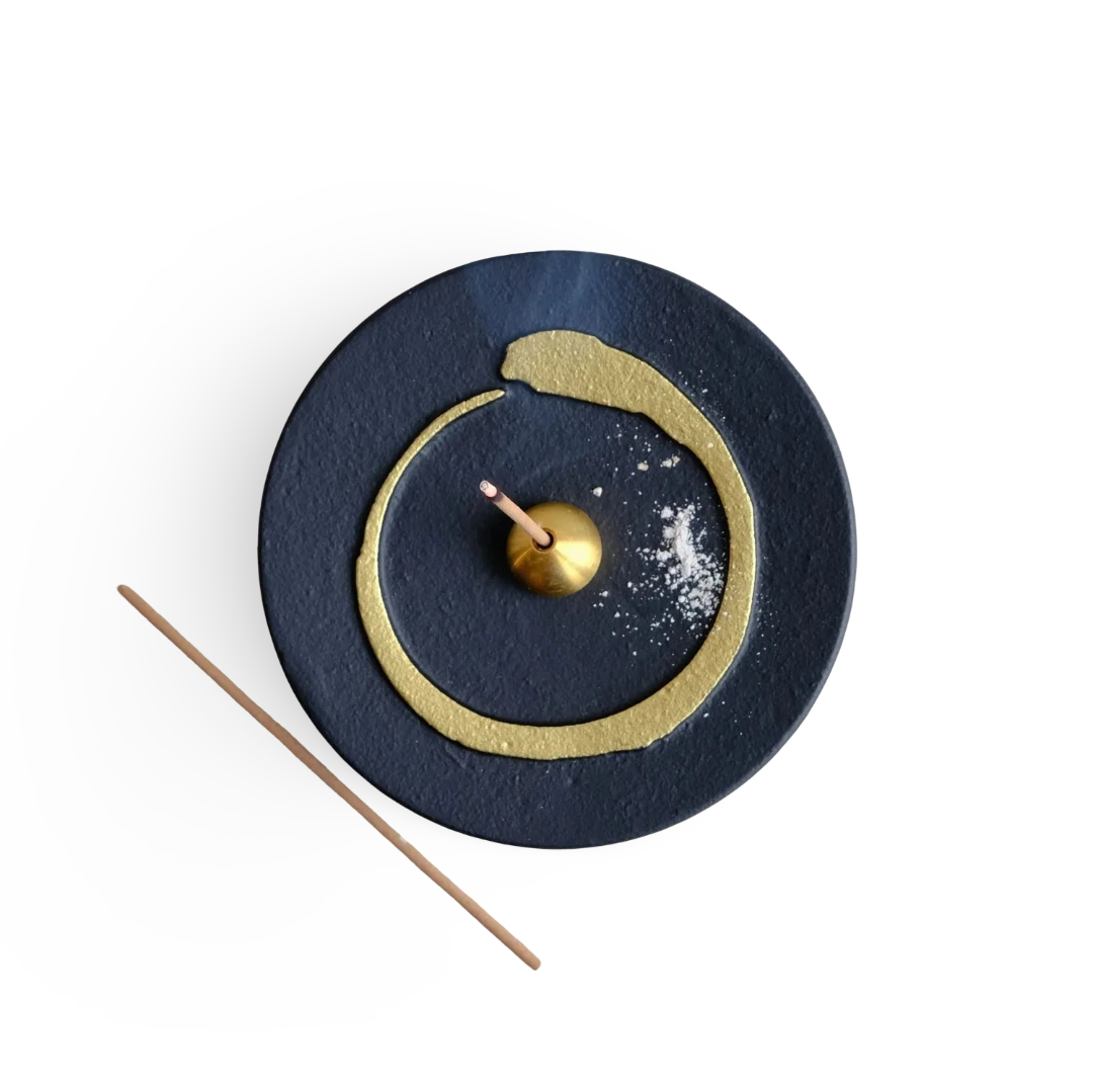 Decorative incense holder with buddhism enso gold circle design on a white background