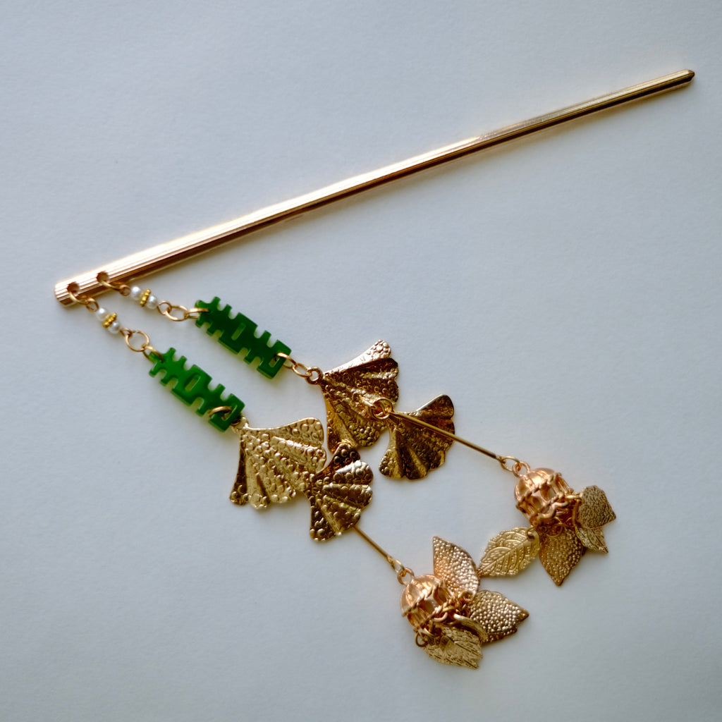 Close up shot of handmade Happiness Duo, Double Happiness(喜) hair pin. Chinese character motif in Jade green, golden color tone, typical Chinese wedding accessories.