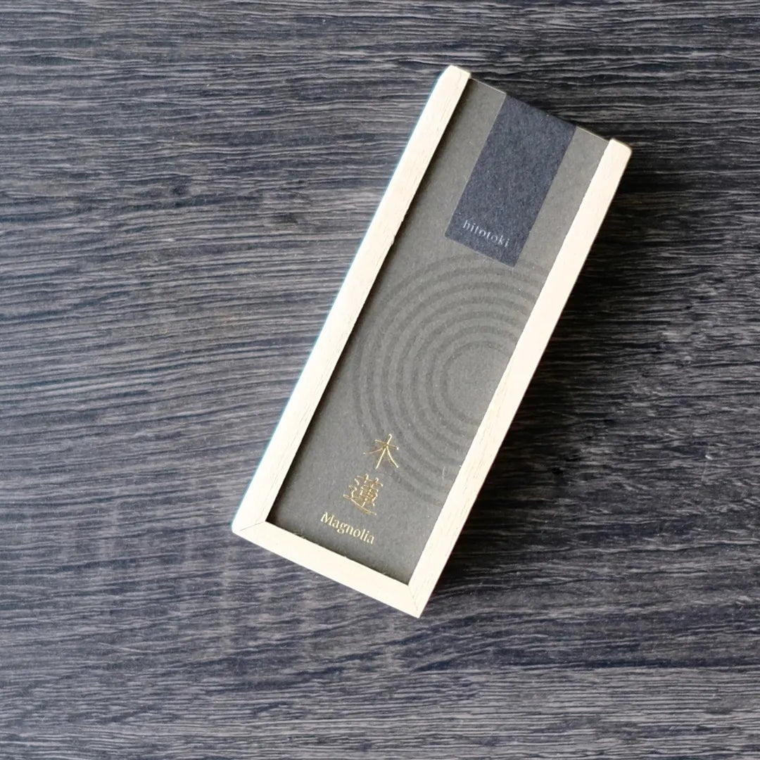 Incense product packaging on a wooden surface with Kousaido Hitotoki brand logo