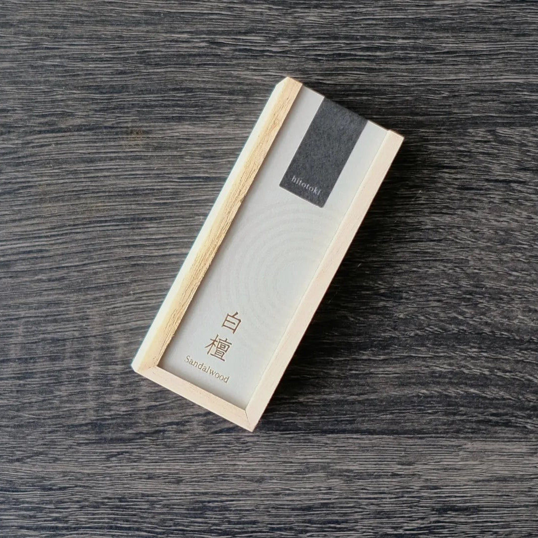 Rectangular Kousaido incense box with a textured surface on a wooden table