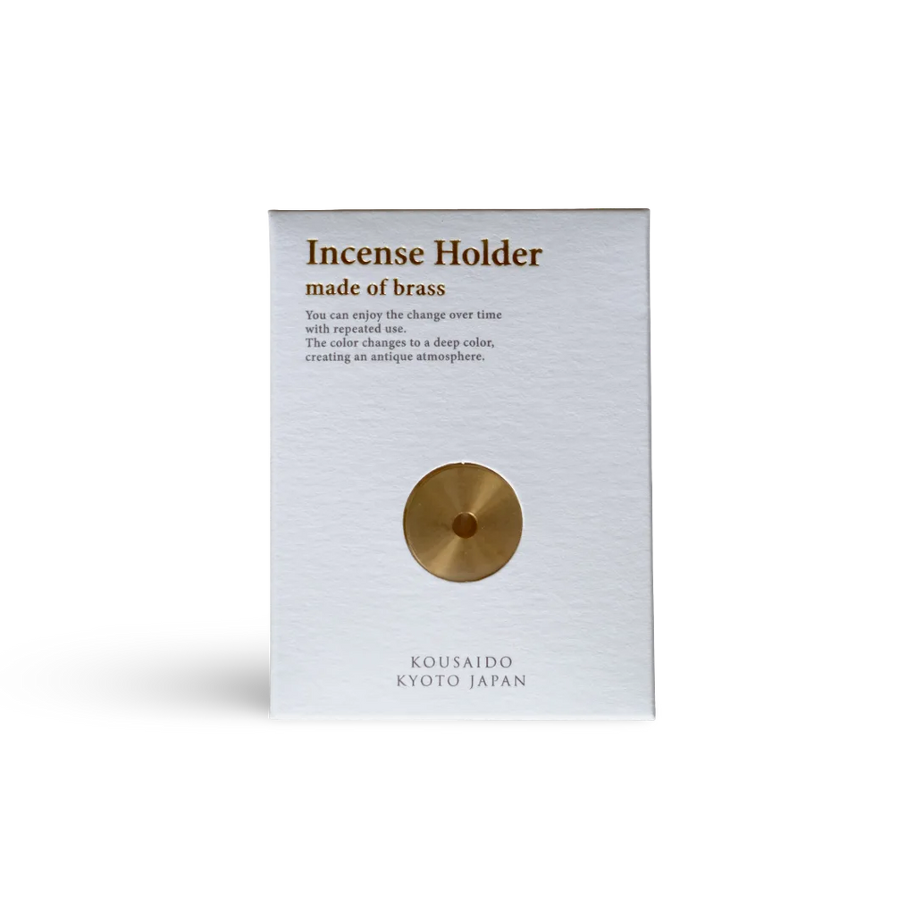 Brass incense holder packaging with text on a white background
