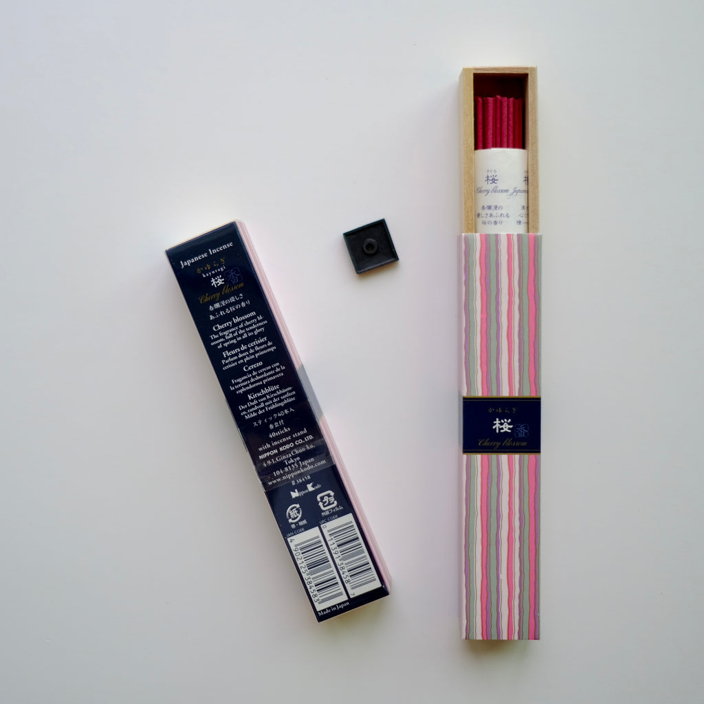 A box of opened KAYURAGI - Cherry Blossom 40 sticks, incense holder outside the box, and another box showing opposite text of the incense package. white background.