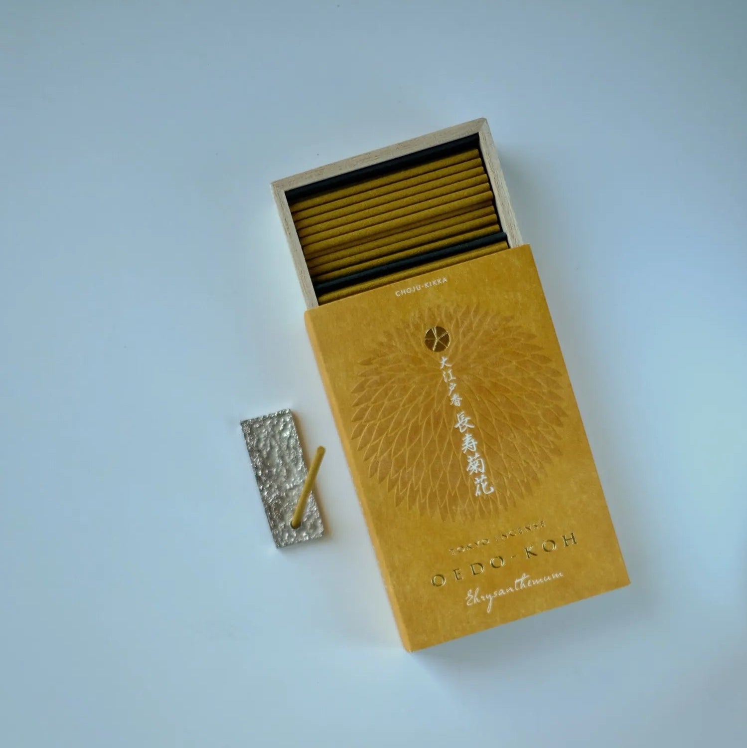 Yellow incense box with matches on a light blue background
