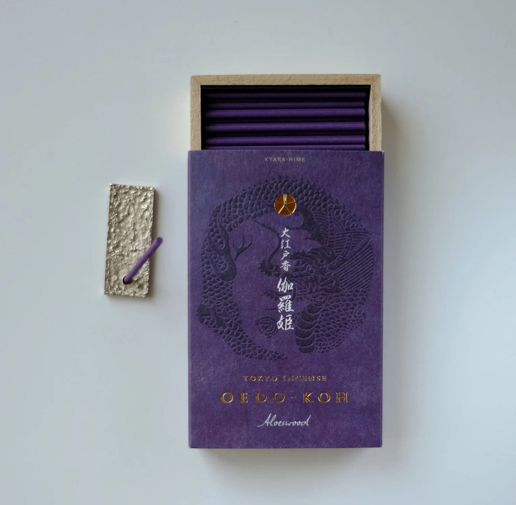 Purple oedo koh aloeswood incense box with open lid showing purple sticks on a light gray background