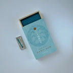 Incense with blue matches and a decorative match on a light gray background
